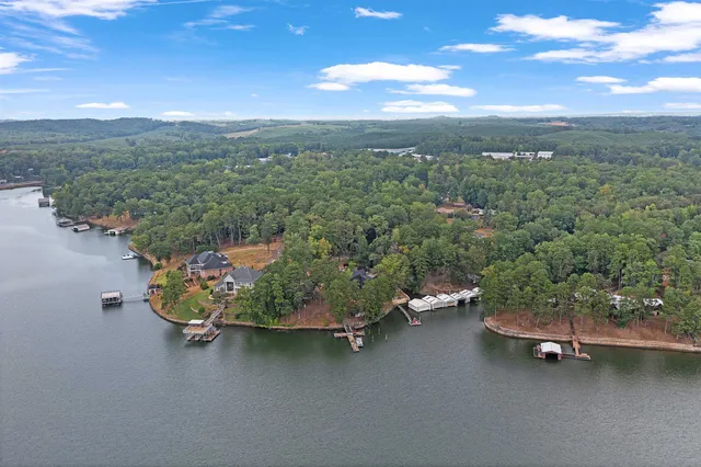 an aerial view of a house with a yard lake and mountain view