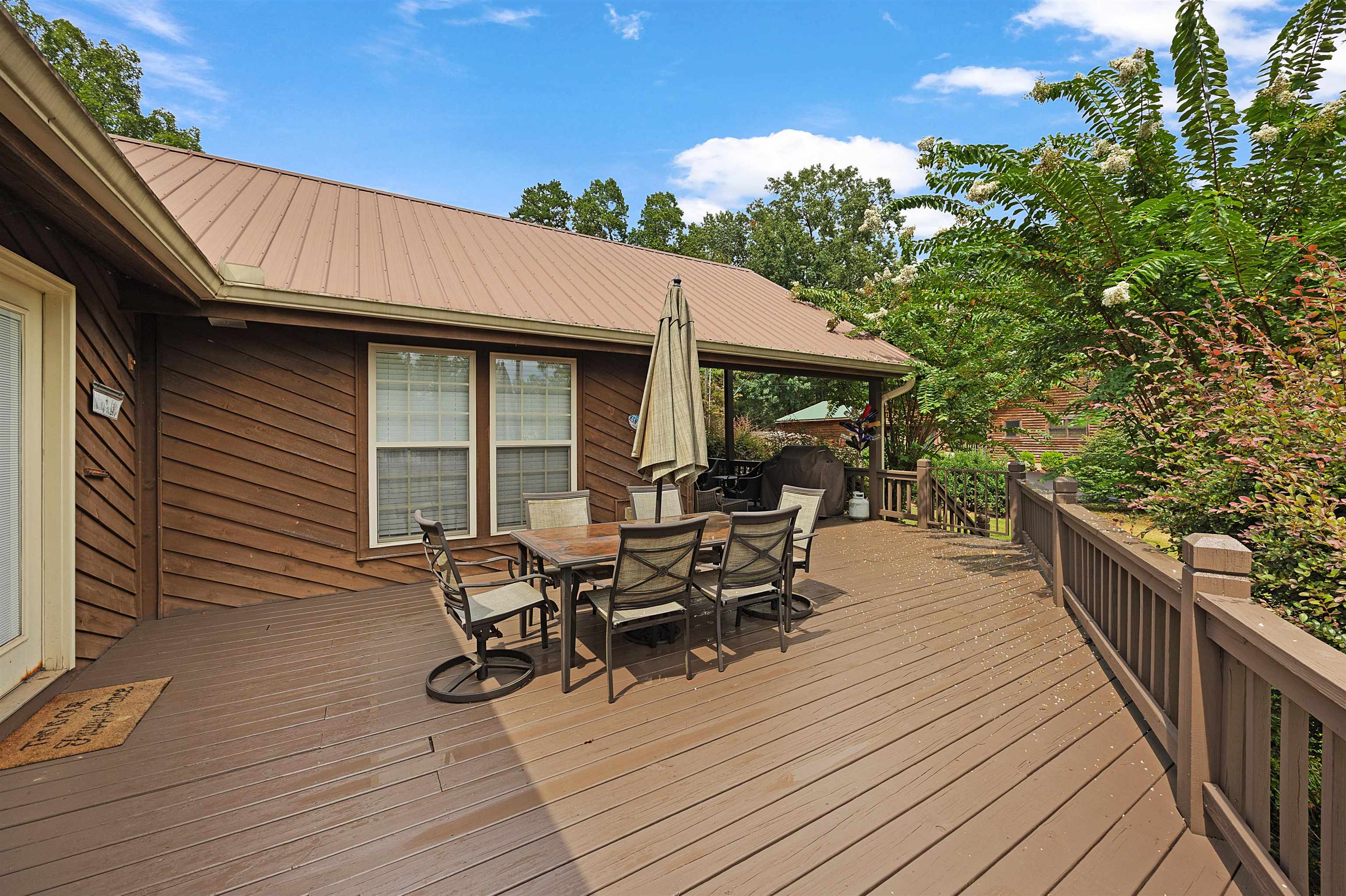 28 County Road 18 Iuka, MS 38852 - Photo 4 of 39 a view of a patio with table and chairs with wooden floor and fence