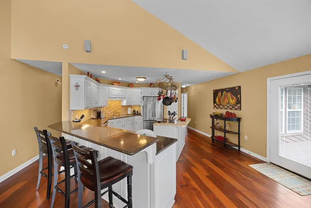 a dining room with furniture and wooden floor