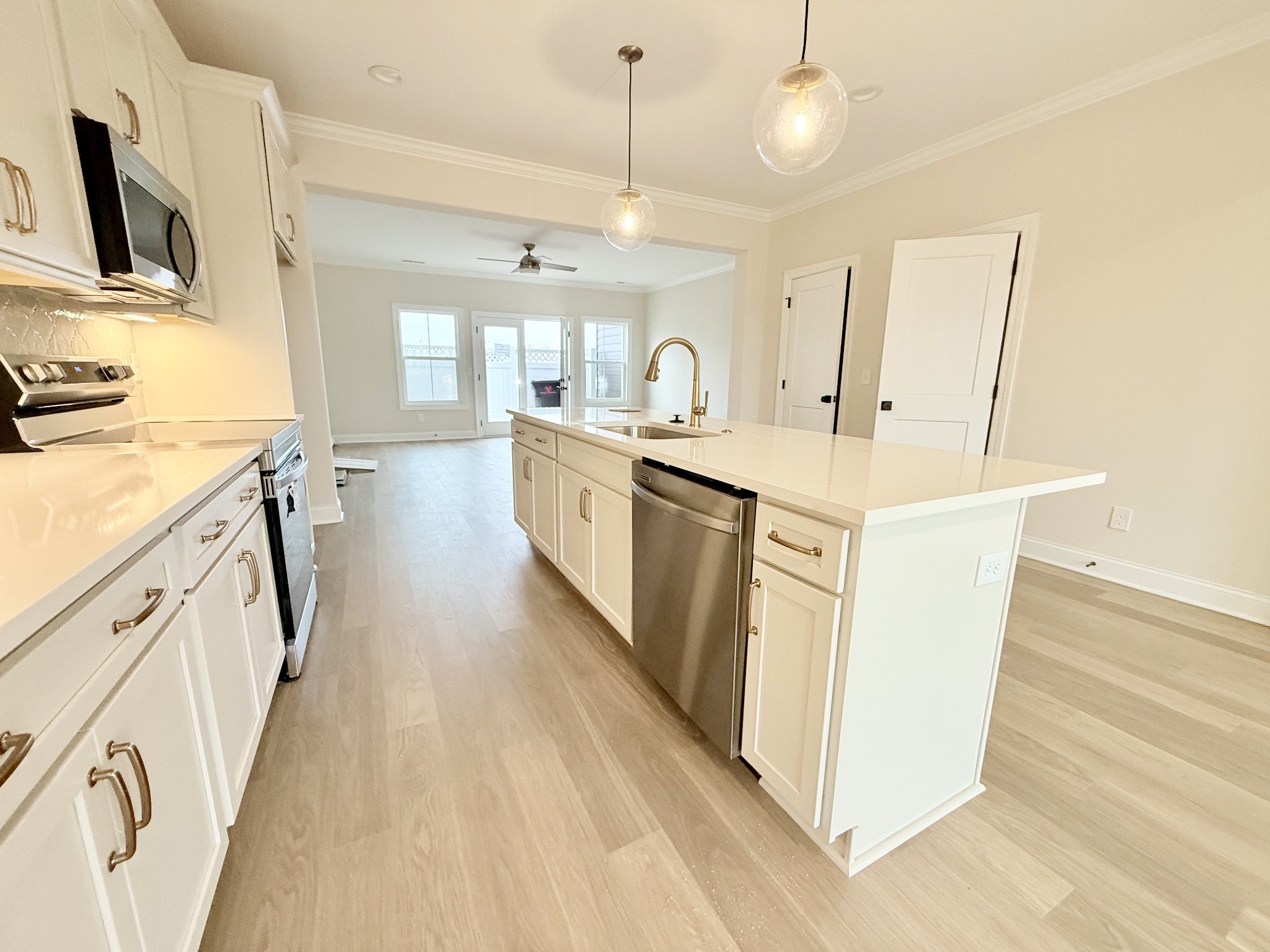 1341 Rebecca Johns Drive Murfreesboro, TN 37128 - Photo 12 of 32 a large kitchen with stainless steel appliances a stove a sink a refrigerator and a wooden floor