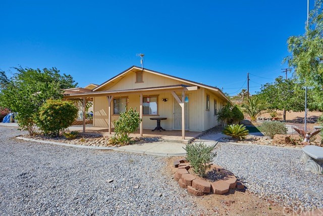 9127 Dover Road Apple Valley, CA 92308 - Photo 1 of 1 a front view of a house with a yard