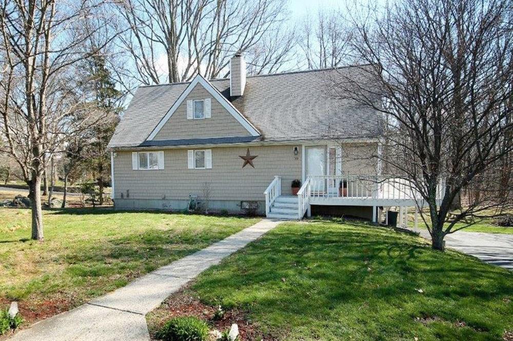 39 Yetter Road Groton, CT 06355 - Photo 1 of 1 a front view of a house with a garden and trees