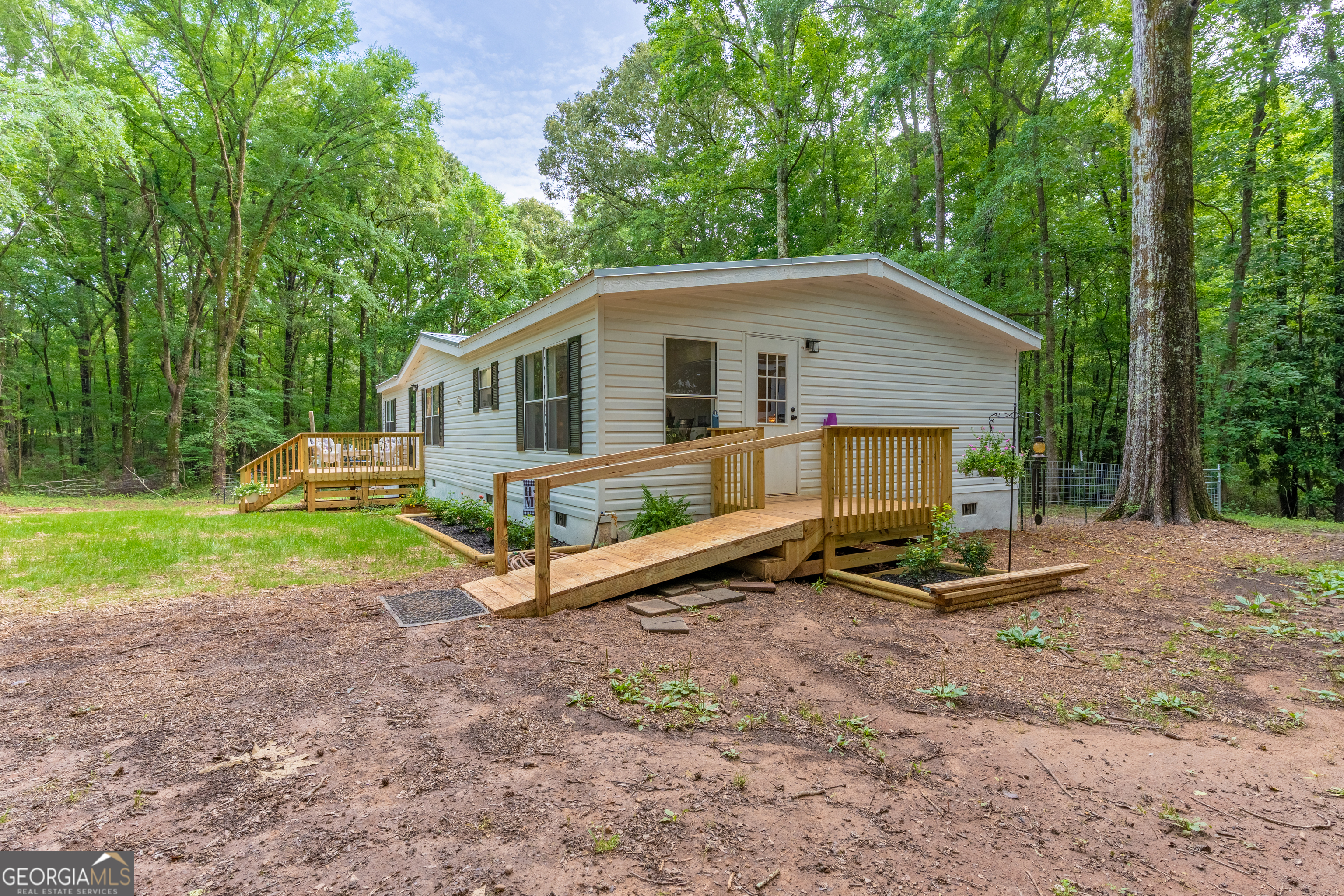 452 Aikenton Road Monticello, GA 31064 - Photo 43 of 47 a view of a house with a yard and large trees