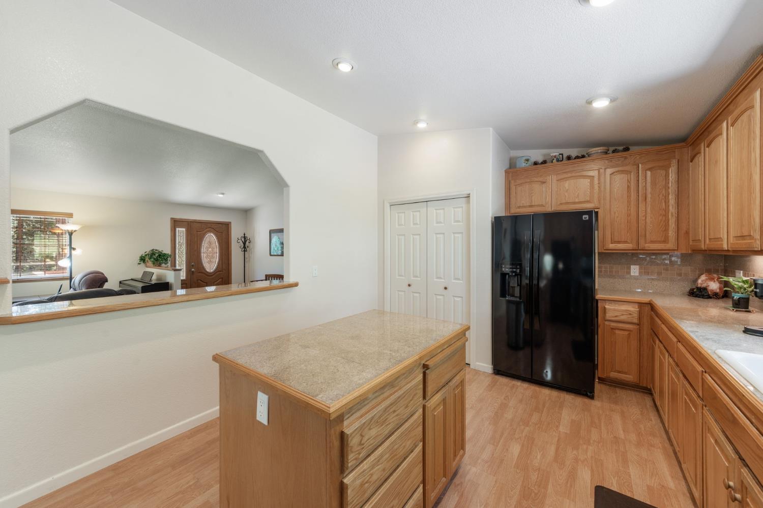 6221 Speckled Road Pollock Pines, CA 95726 - Photo 13 of 41 a kitchen with a refrigerator and a sink