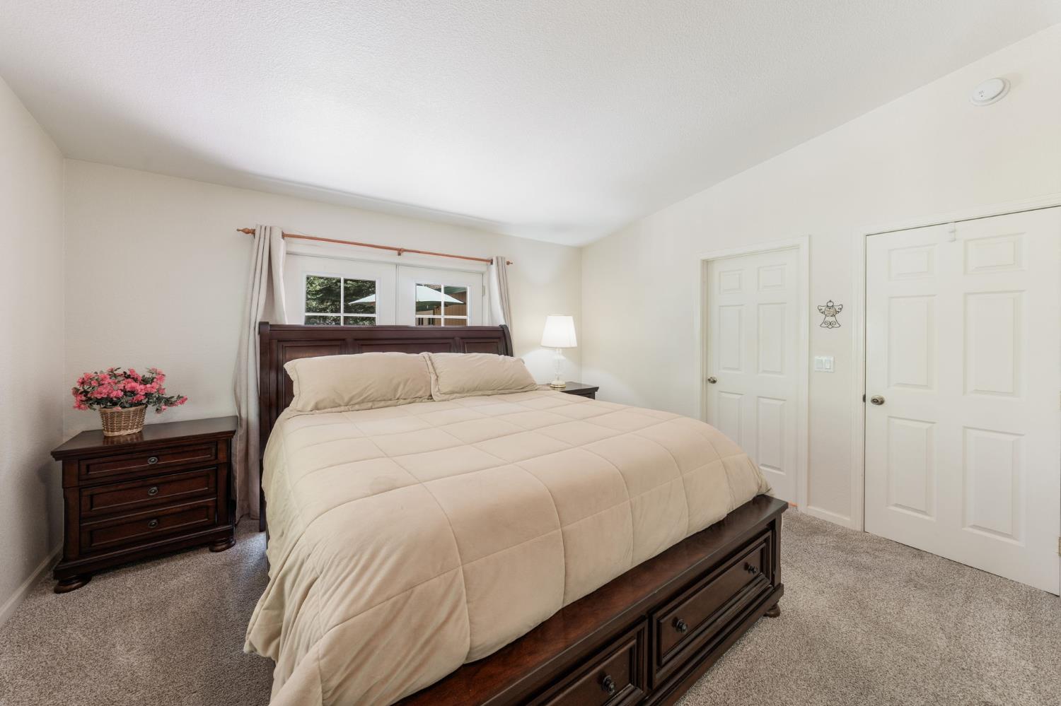 6221 Speckled Road Pollock Pines, CA 95726 - Photo 17 of 41 a bedroom with a bed and a chandelier