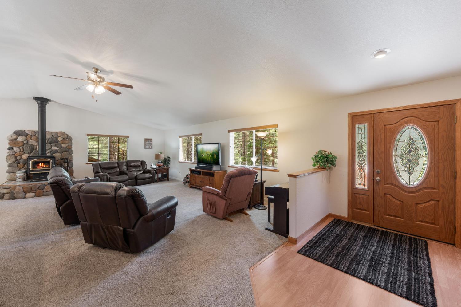 6221 Speckled Road Pollock Pines, CA 95726 - Photo 3 of 41 a living room with furniture a table and wooden floor