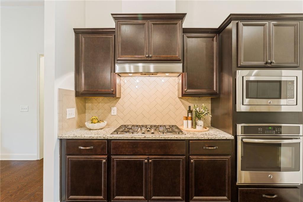 4735 Amble Trace Cumming, GA 30040 - Photo 35 of 73 a kitchen with a sink and a refrigerator