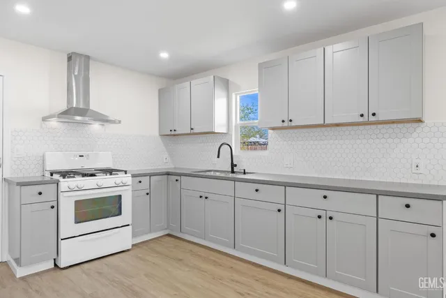 a kitchen with white cabinets and white appliances