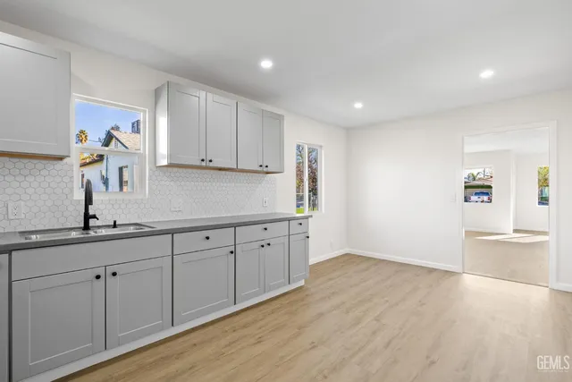 a kitchen with sink and cabinets