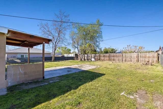 a view of a swimming pool with an outdoor seating and a yard
