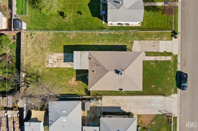 an aerial view of a residential houses with outdoor space