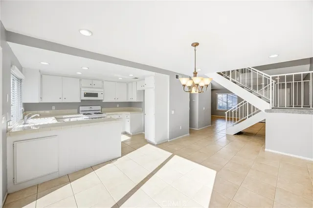 a kitchen with stainless steel appliances kitchen island sink refrigerator and stove