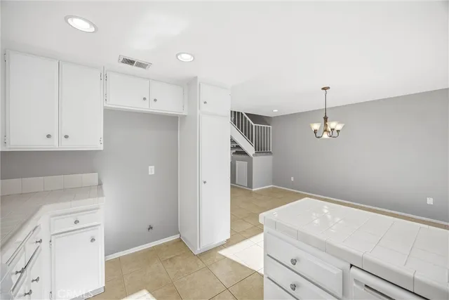 a kitchen with white cabinets and white appliances