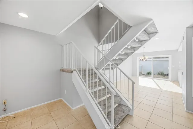 an empty room with closet and chandelier fan