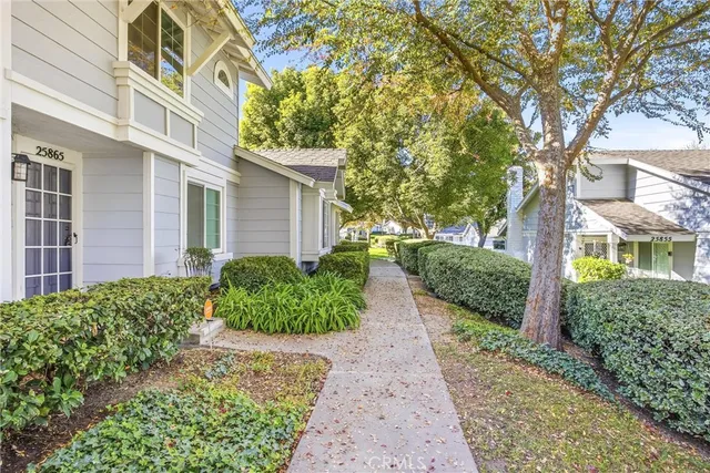 a view of a pathway with a house in the background