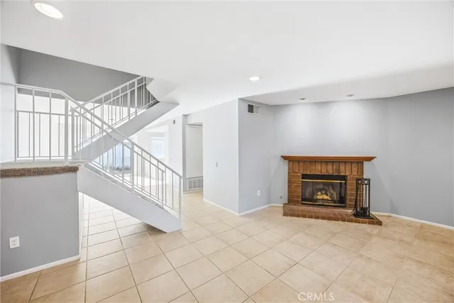 a view of an empty room and fire place