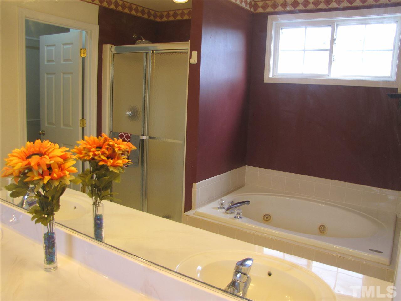 2309 Folger Street Raleigh, NC 27604 - Photo 14 of 23 a bath tub sitting next to a blue sink
