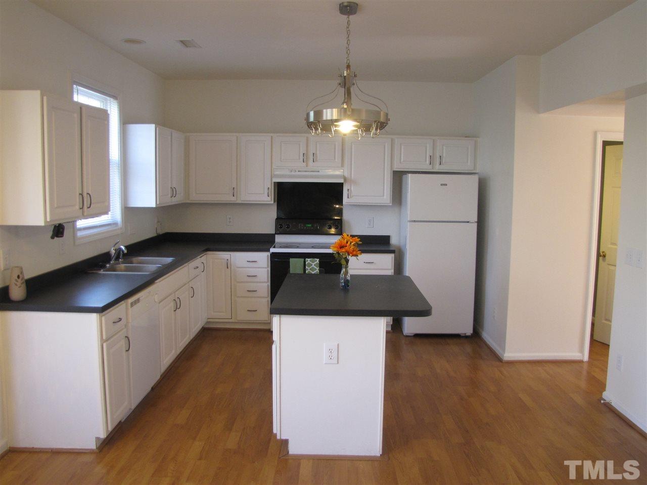 2309 Folger Street Raleigh, NC 27604 - Photo 6 of 23 a kitchen with a stove a sink and a refrigerator