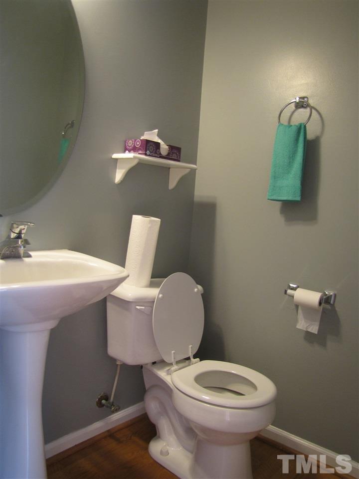 2309 Folger Street Raleigh, NC 27604 - Photo 9 of 23 a bathroom with a toilet a sink and mirror