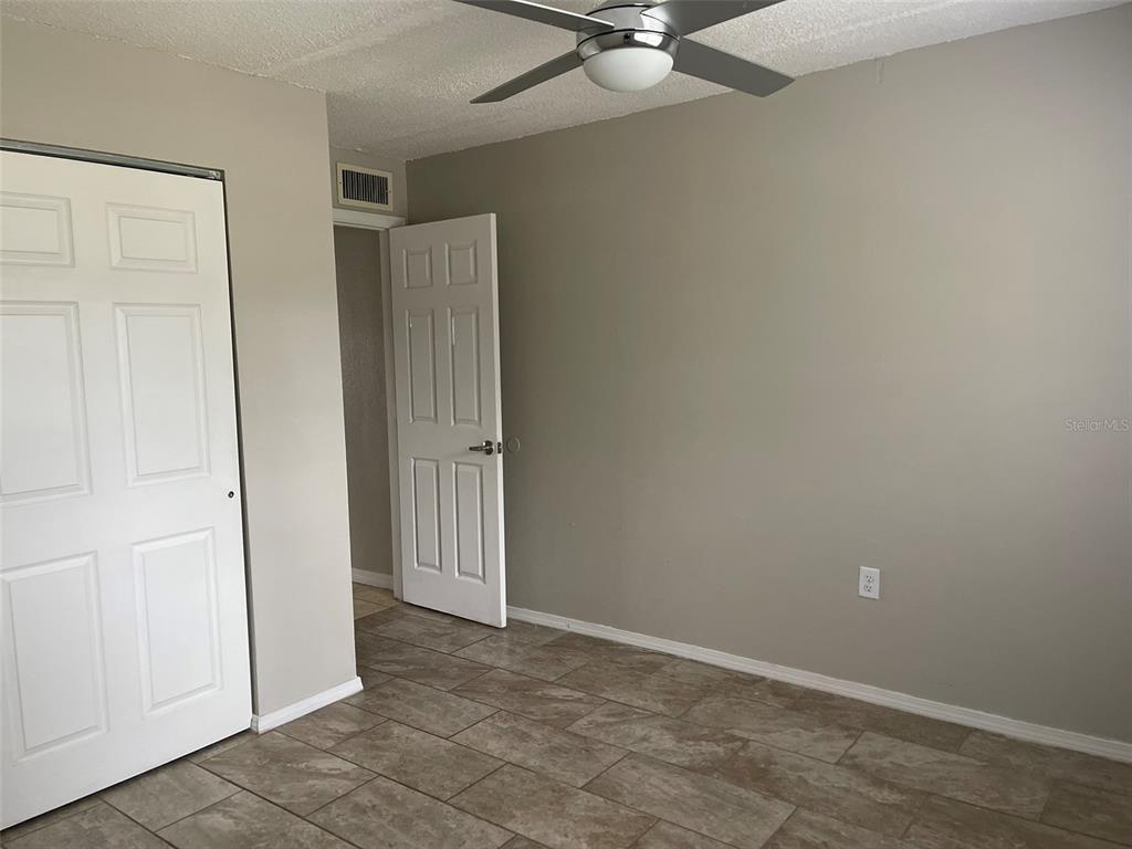 525 South Conway Road, Unit 109 Orlando, FL 32807 - Photo 13 of 18 an empty room with closet and fan