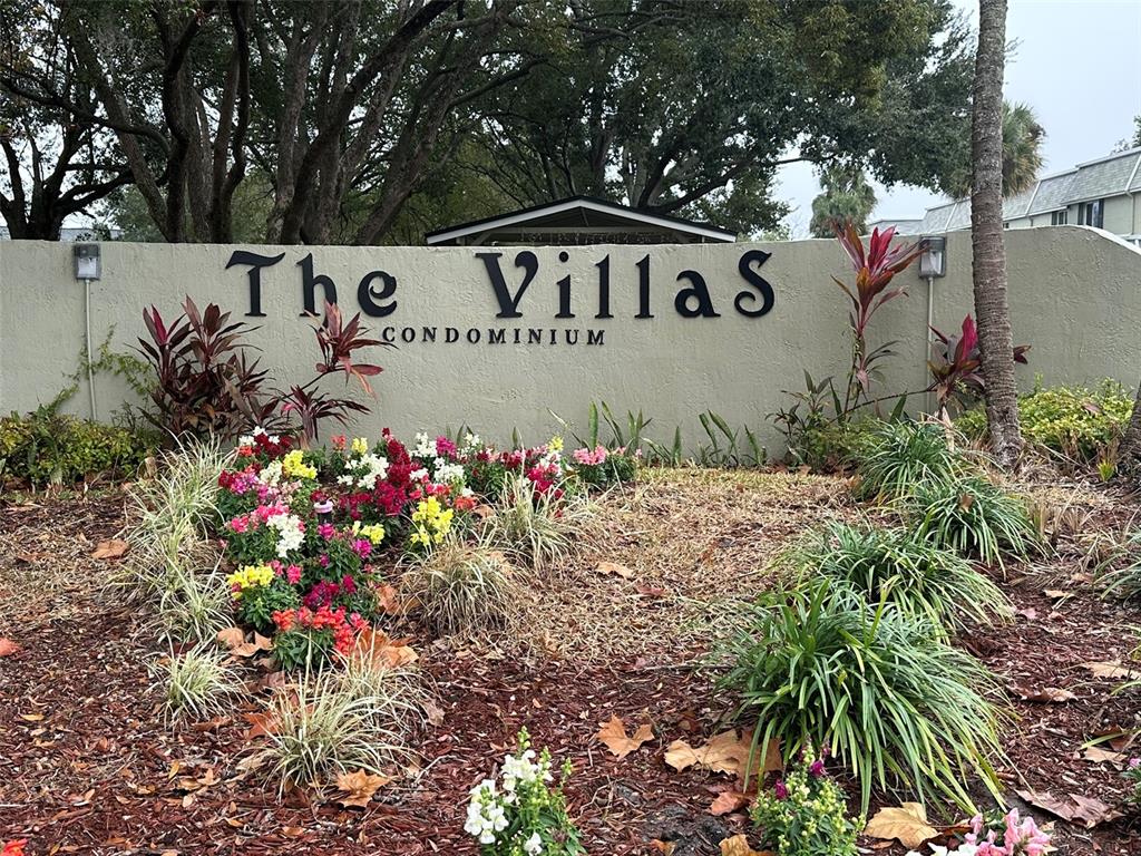 525 South Conway Road, Unit 109 Orlando, FL 32807 - Photo 18 of 18 a view of a sign in front of flowers