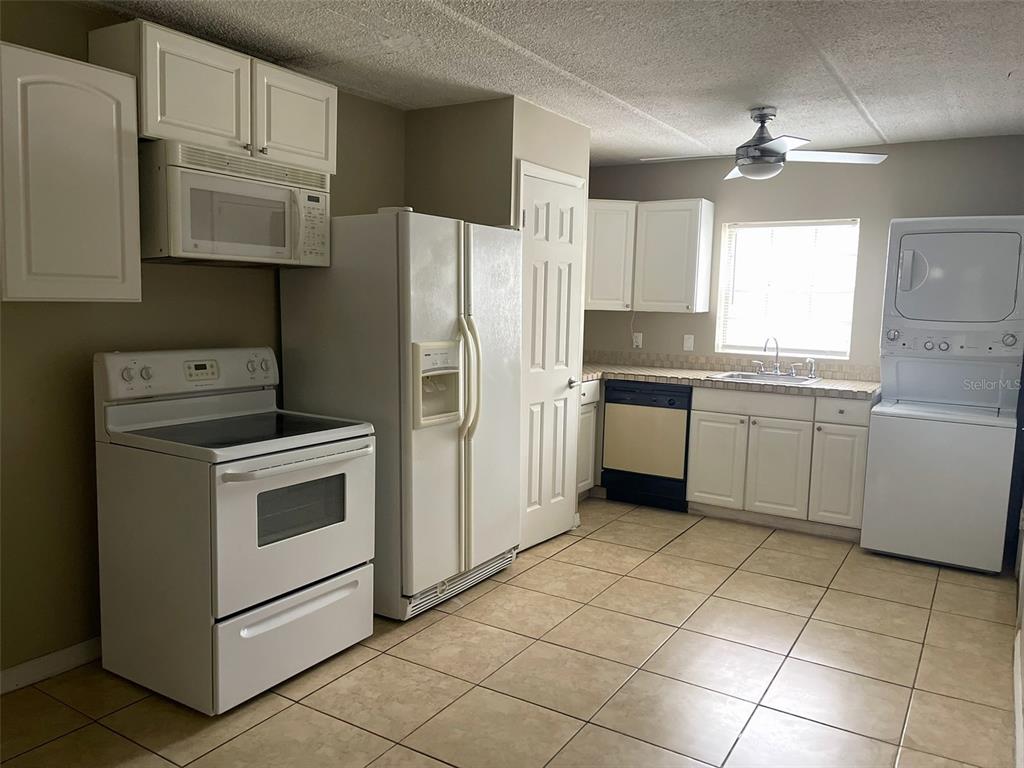 525 South Conway Road, Unit 109 Orlando, FL 32807 - Photo 7 of 18 a kitchen with a stove sink and refrigerator