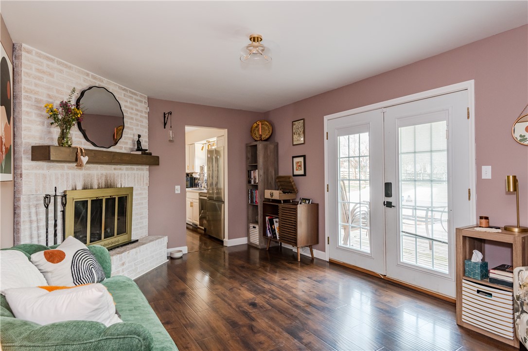 4102 Ridgetop Drive Bellbrook, OH 45305 - Photo 12 of 33 This inviting living area features warm wood flooring and a cozy fireplace, perfect for relaxation.