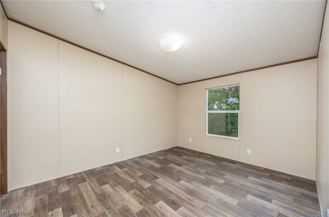 7455 Stanleyville Road Whipple, OH 45788 - Photo 20 of 37 Room featuring wood-finish flooring, light-colored walls, and a single window
