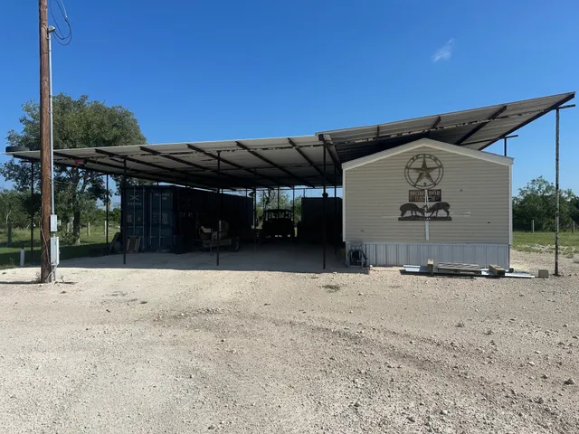 a living room with furniture a flat screen tv and kitchen view