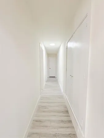 a spacious bathroom with 2 sink tub and a mirror