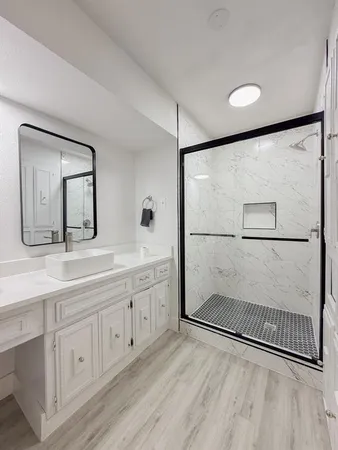 a bathroom with a double vanity sink and mirror
