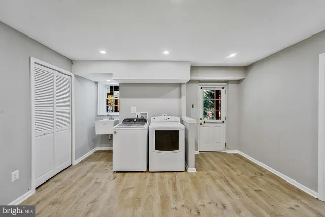 a view of a kitchen with wooden floor and electronic appliances