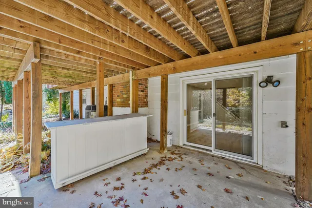 a view of a porch with a table and chairs
