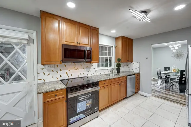 a kitchen with stainless steel appliances granite countertop a sink and cabinets