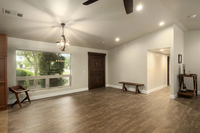 a view of a room with gym equipment and large windows