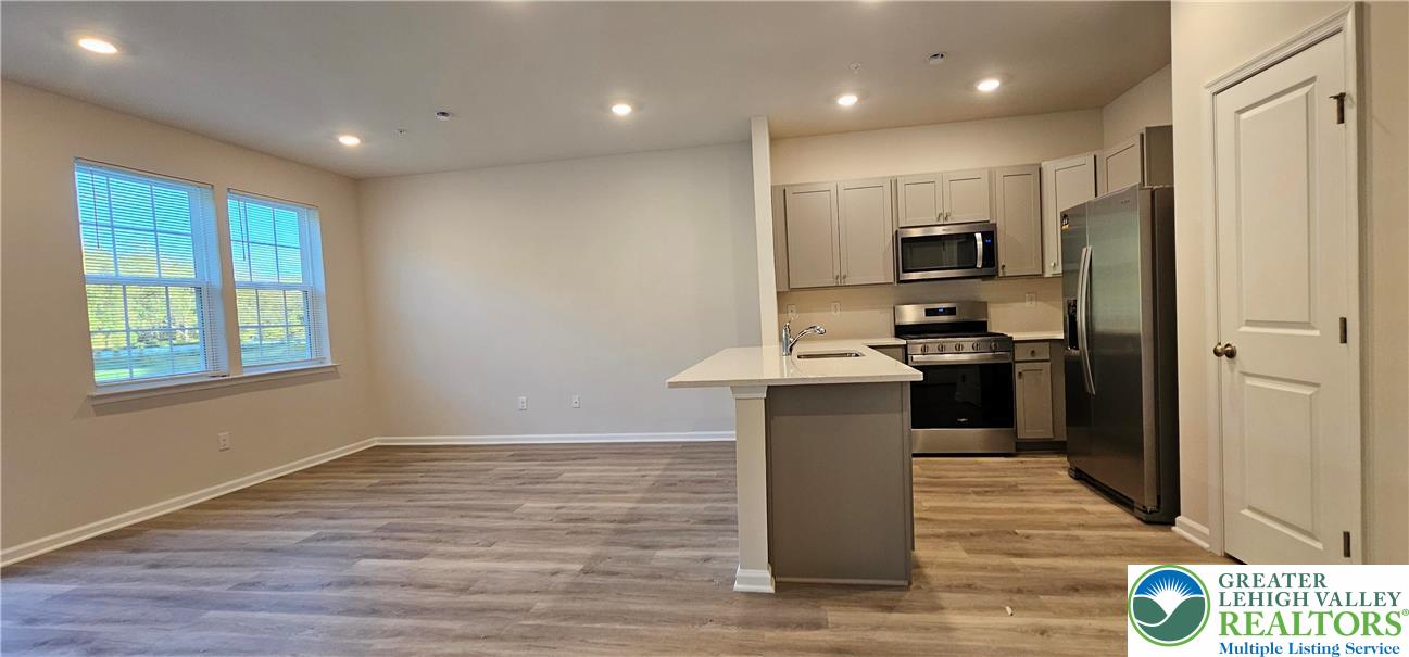 1151 Martin Road Breinigsville, PA 18031 - Photo 4 of 15 a kitchen with kitchen island a sink appliances and cabinets
