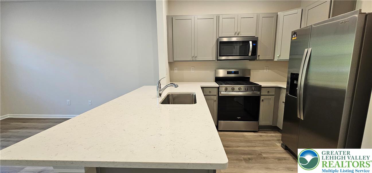1151 Martin Road Breinigsville, PA 18031 - Photo 5 of 15 a kitchen with a refrigerator and a stove