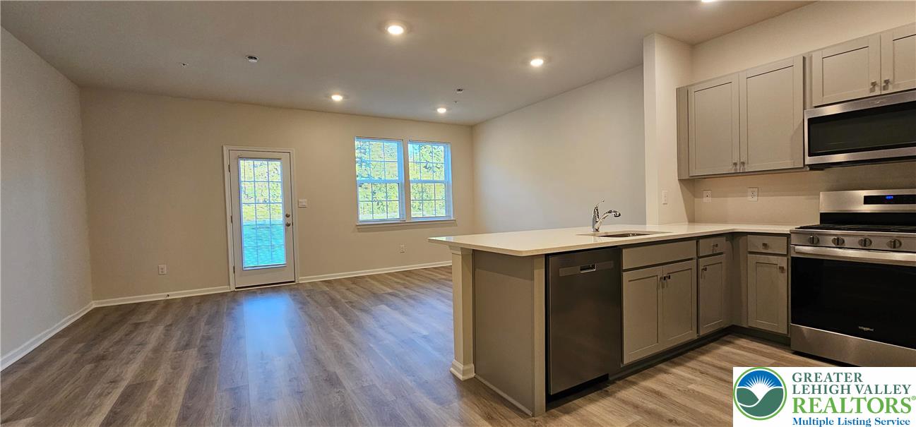 1151 Martin Road Breinigsville, PA 18031 - Photo 7 of 15 a kitchen with sink cabinets and wooden floor