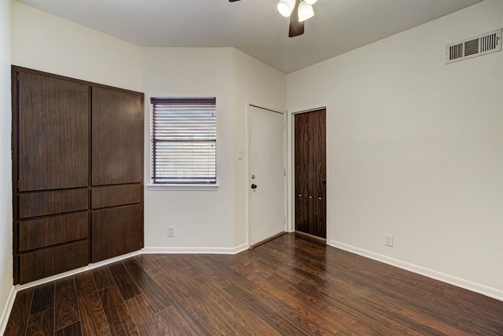 3316 Guadalupe Street, Unit 219 Austin, TX 78705 - Photo 4 of 13 an empty room with wooden floor cabinet and windows