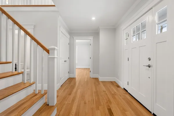 a view of a room with wooden floor and staircase