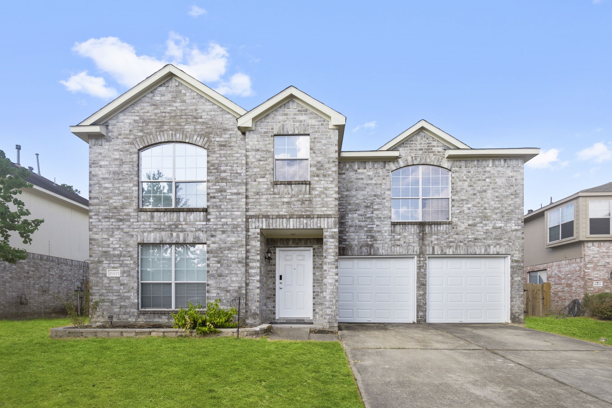 a front view of a house with a yard and garage