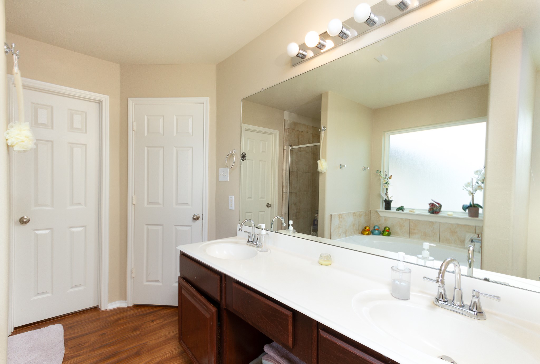 1107 Arum Road Missouri City, TX 77489 - Photo 15 of 23 a bathroom with a double vanity sink a mirror and a shower