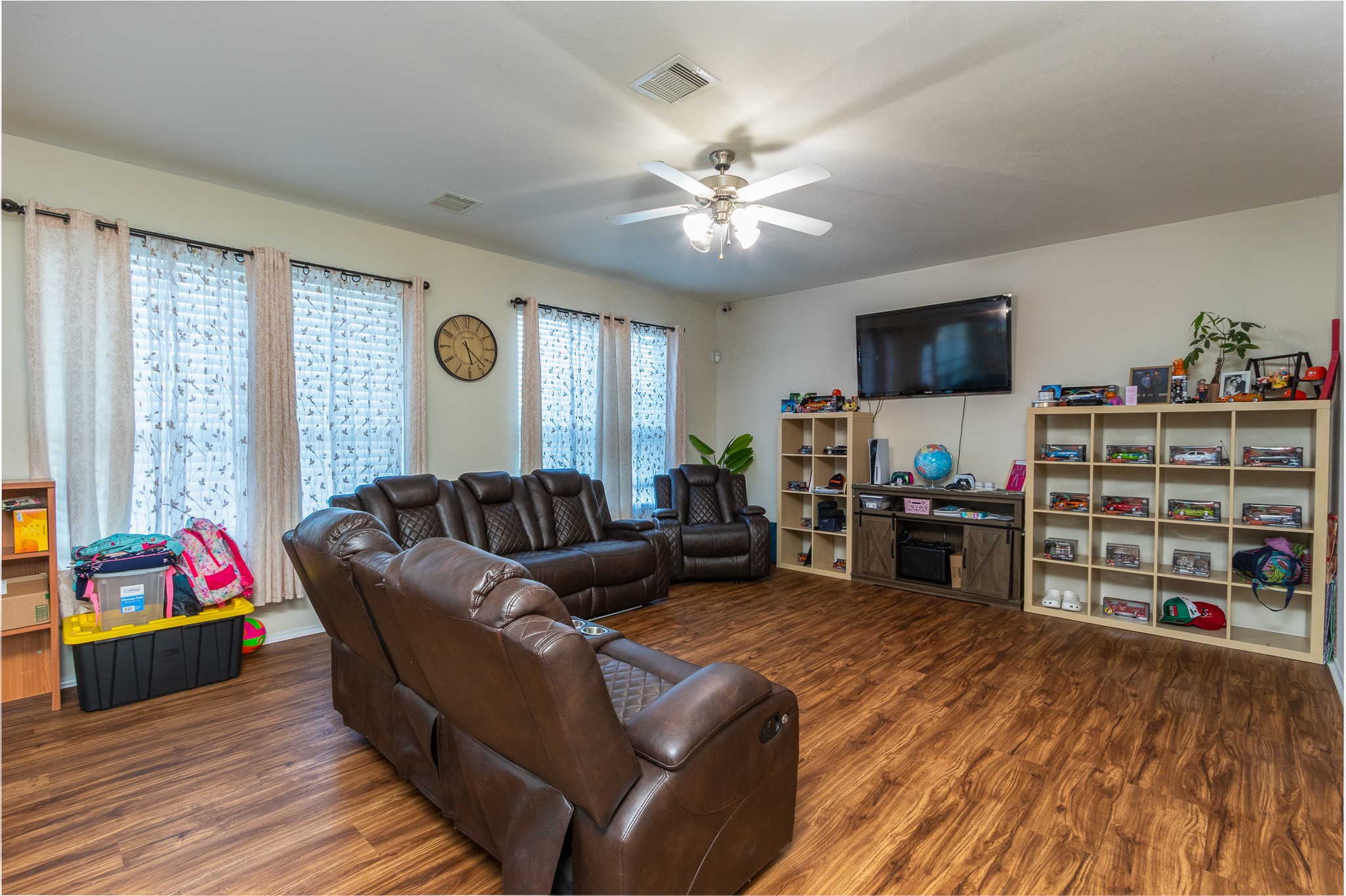 1107 Arum Road Missouri City, TX 77489 - Photo 9 of 23 a living room with furniture a flat screen tv and a floor to ceiling window