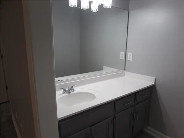 a bathroom with a sink vanity and a mirror