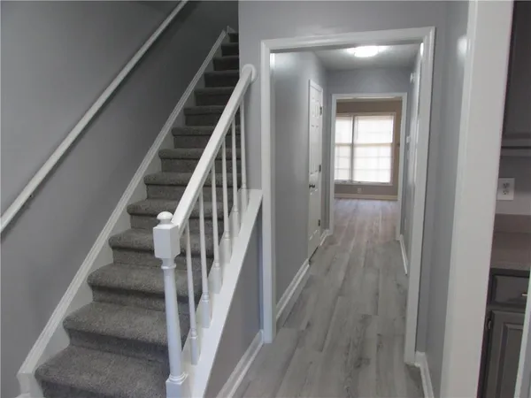 a view of an entryway with wooden floor and staircase