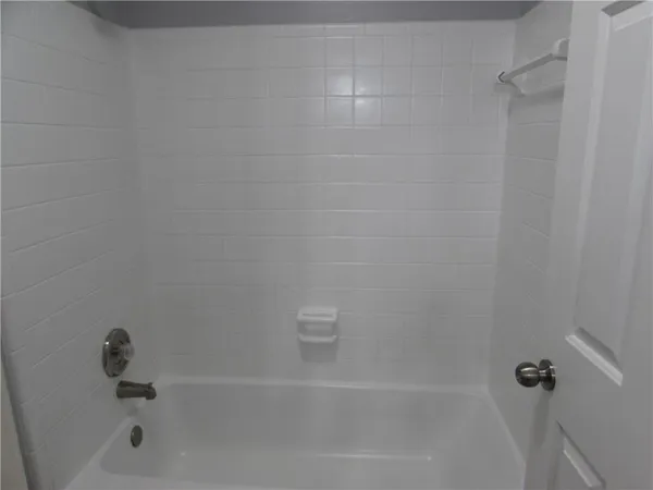 an empty room with wooden floor and a window