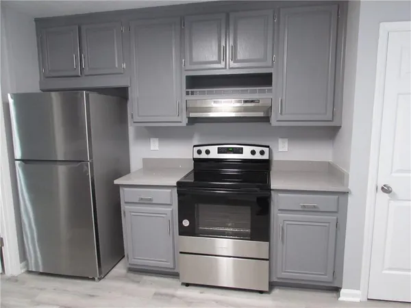 a kitchen with a stove and a microwave