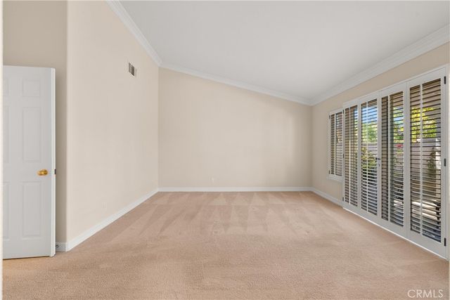 a view of a patio with table and chairs with wooden floor and fence