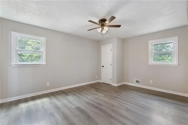 wooden floor in an empty room with a window