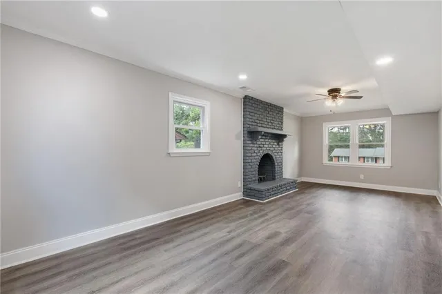 a view of an empty room and wooden floor